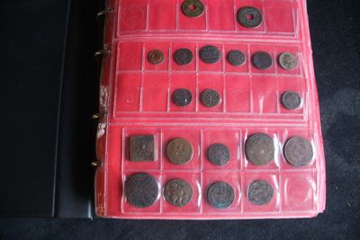 a red case with a lot of coins in it
