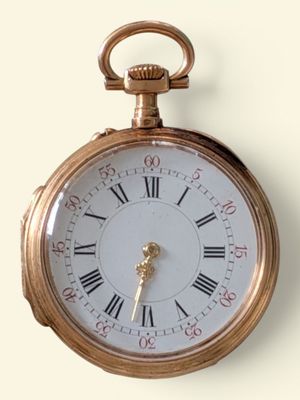 une montre de poche en or avec des chiffres romains sur le cadran