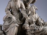 statue of a woman with a guitar and two other women