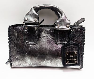 an image of a silver purse with a tag on it
