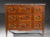 an antique chest of drawers with marble top