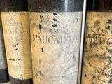 four bottles of wine are lined up on a counter