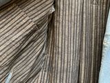 a close up of a striped shirt hanging on a clothes rack