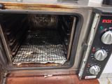 a dirty oven with the door open on the floor