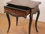 a small table with a drawer on top of it