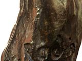 bronze statue of a woman ' s head with a face made out of metal
