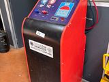 a machine that is sitting on the floor next to a fire hydrant