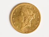 a close up of a gold coin on a white surface