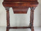 a small wooden table with a drawer on top of it