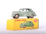 a green toy car sitting on top of a yellow box