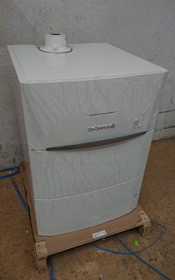 a white refrigerator sitting on a pallet in the middle of a room