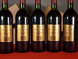 four bottles of wine are lined up on a table