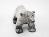 a black and white polar bear figurine on a white surface