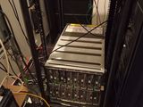 a rack with many electronic equipment on it in a room