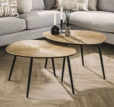 two tables that are sitting on the floor in the living room