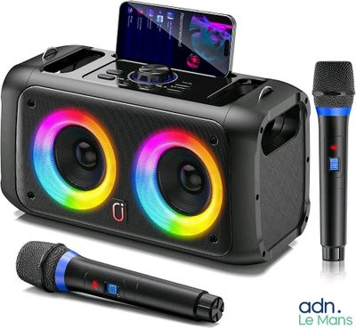 a close up of a speaker with two microphones and a cell phone