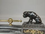 a statue of a dog on top of a sword