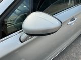 a silver car with a mirror on the side of it