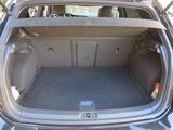 the back of a car with the trunk open and the back door open
