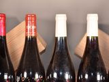 several bottles of wine are lined up on a table