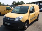 a yellow van parked in a parking lot next to a yellow van
