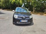 a small black car parked on the side of the road
