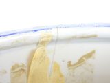 a white bowl with a yellow piece of food on it