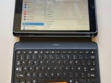 a laptop and a tablet on a table with a sticky note on it