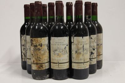 six bottles of wine are lined up in a row on a white surface