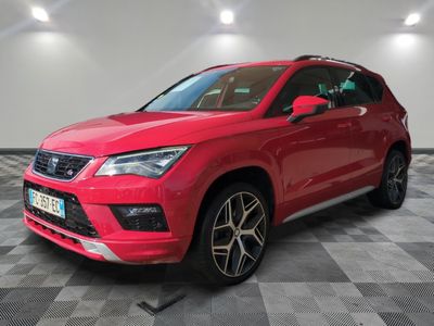 a red seat aten suv parked on a checkered floor