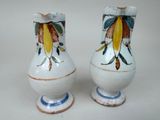 two vases that have been painted with flowers on them