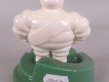a figurine of a man on a green base