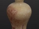 a picture of a small vase with a brown lid