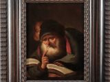 painting of an old man reading a book in a wooden frame