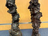 two bronze sculptures of a woman and a man on a pedestal