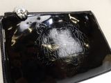 a black purse with a picture of a tiger on it