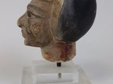 sculpture of a man ' s head on a marble base on a white surface