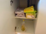 a small cabinet with a lot of towels on it