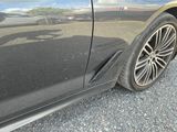 a close up of a car ' s tire on a gravel road