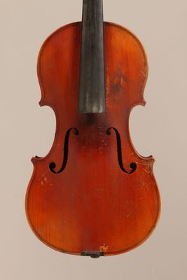an old violin with a bow hanging from it ' s back