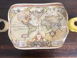 a table with a cup of coffee and a map of the world on it