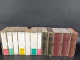 several books are stacked on top of each other on a table