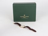 an image of a watch sitting on top of a green box