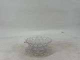 a glass bowl that is sitting on the ground