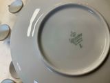 a white plate with a green design on it