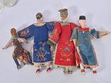 three dolls that are sitting next to each other on a table