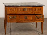 a marble top chest of drawers on a wooden stand