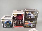 several boxes of batman pop vinyl figures are stacked on top of each other
