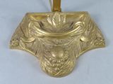 gold plated candle holder with a gold ribbon on a white background