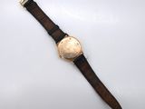 a close up of a watch on a white surface with a white background